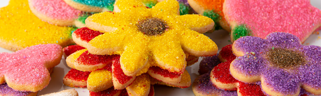 Colorful flower-shaped sugar cookies display.